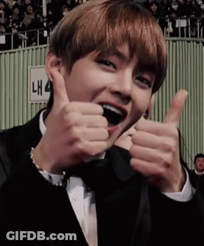 A Man In A Tuxedo Is Giving Two Thumbs Up . GIF
