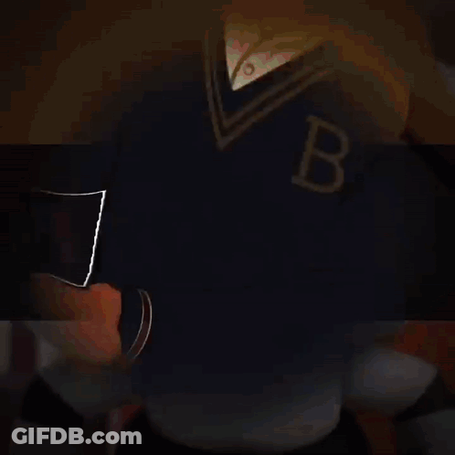 A Man In A Tuxedo Is Holding A Bat With The Letter B On It GIF
