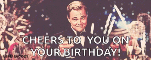 A Man In A Tuxedo Is Holding A Glass Of Champagne And Says Cheers To You On Your Birthday GIF