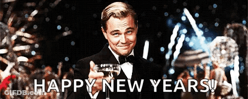 A Man In A Tuxedo Is Holding A Glass Of Champagne With The Words Happy New Years Behind Him GIF