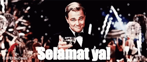A Man In A Tuxedo Is Holding A Gun And Says Selamat Ya GIF