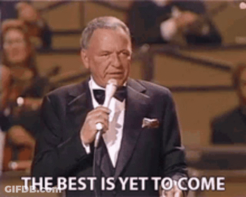 A Man In A Tuxedo Is Holding A Microphone And Saying The Best Is Yet To Come GIF