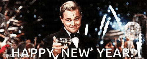A Man In A Tuxedo Is Holding A Trophy And The Words Happy New Year Are Below Him GIF
