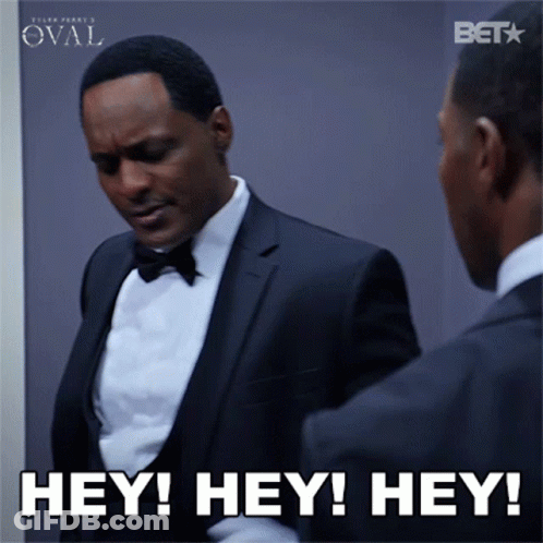 A Man In A Tuxedo Is Looking At Himself In The Mirror And Says Hey Hey Hey GIF