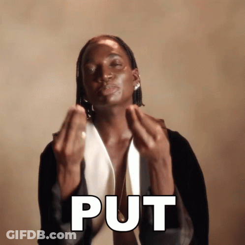 A Man In A Tuxedo Is Making A Gesture That Says " Put " GIF