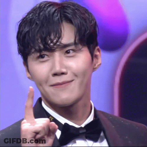 A Man In A Tuxedo Is Pointing Up With His Index Finger GIF