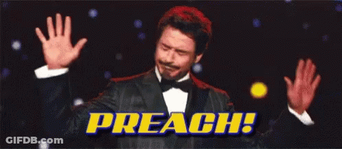 A Man In A Tuxedo Is Raising His Hands In The Air With The Words Preach Behind Him . GIF