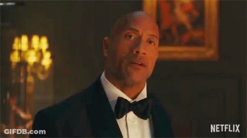 A Man In A Tuxedo Is Saying `` You 'Re Under Arrest '' In A Room . GIF