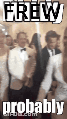 A Man In A Tuxedo Is Standing In Front Of A Sign That Says Brew Probably GIF