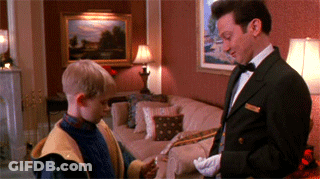 A Man In A Tuxedo Is Standing Next To A Boy In A Living Room GIF