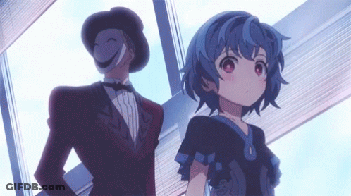 A Man In A Tuxedo Is Standing Next To A Girl With Blue Hair . GIF