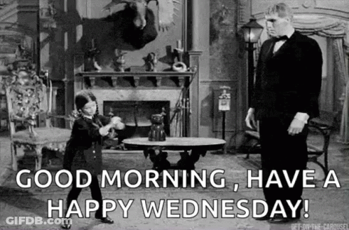 A Man In A Tuxedo Is Standing Next To A Little Boy In A Room . GIF
