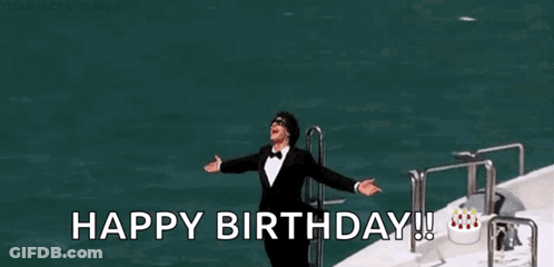 A Man In A Tuxedo Is Standing On A Boat With His Arms Outstretched And The Words `` Happy Birthday ! '' GIF