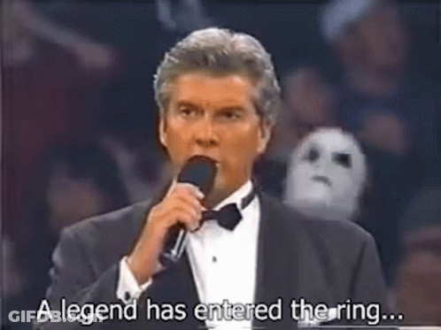 A Man In A Tuxedo Is Talking Into A Microphone And Saying `` A Legend Has Entered The Ring ... '' GIF