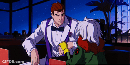 A Man In A Tuxedo Is Talking To A Girl With A X-Men Logo On Her Jacket GIF