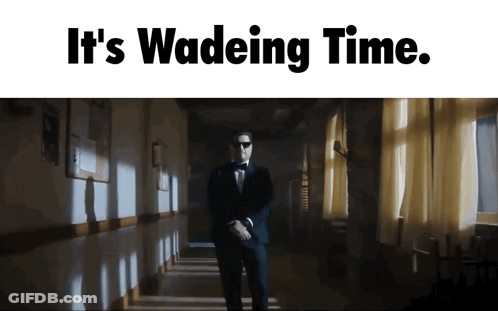 A Man In A Tuxedo Is Walking Down A Hallway With The Words " It 'S Wadeing Time " GIF