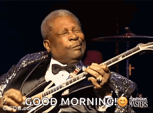 A Man In A Tuxedo Playing A Guitar With The Words Good Morning On The Bottom GIF