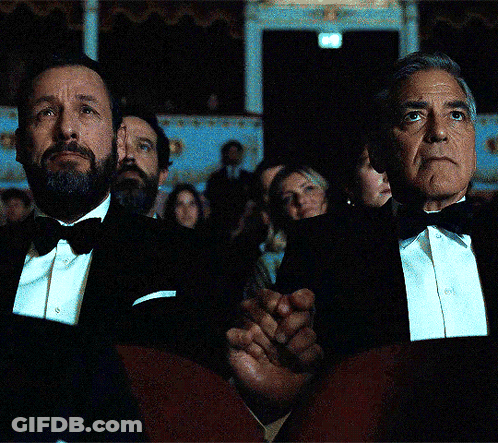 A Man In A Tuxedo Sits Next To Another Man In A Tuxedo GIF