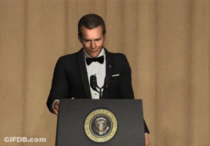 A Man In A Tuxedo Stands Behind A Podium That Says President Of The United States GIF