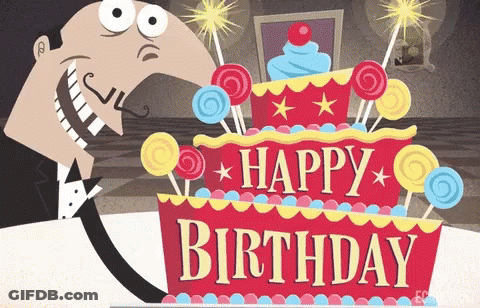 A Man In A Tuxedo Stands In Front Of A Birthday Cake GIF