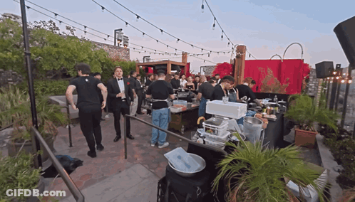 A Man In A Tuxedo Stands In Front Of A Crowd GIF
