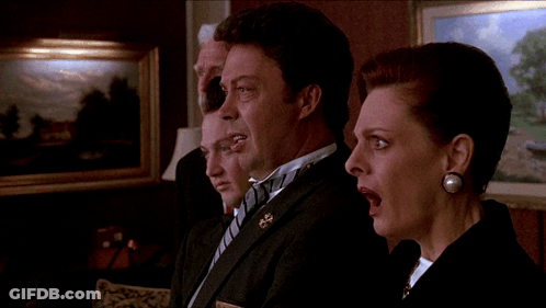 A Man In A Tuxedo Stands Next To A Woman GIF