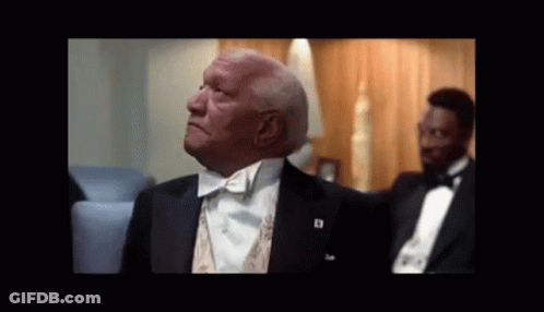 A Man In A Tuxedo With A Badge That Says D On It GIF