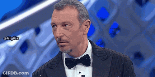 A Man In A Tuxedo With A Bow Tie Has The Hashtag Gigigx On The Bottom Right GIF