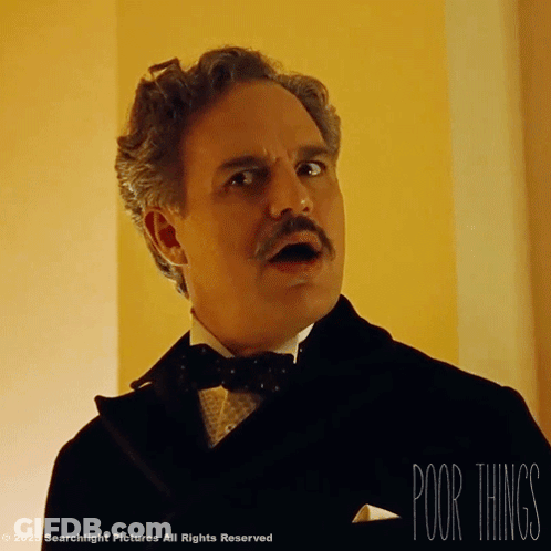 A Man In A Tuxedo With A Mustache And The Words " Poor Things " Below Him GIF