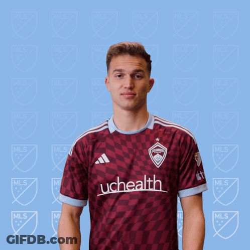 A Man In A Uchealth Jersey Holds A Red Card GIF