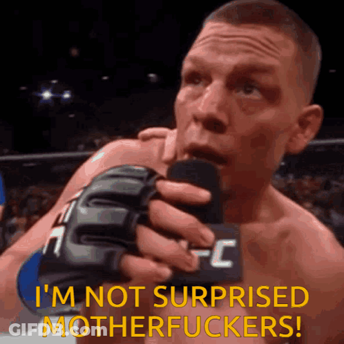 A Man In A Ufc Glove Is Holding A Microphone And Saying I 'M Not Surprised Motherfuckers GIF