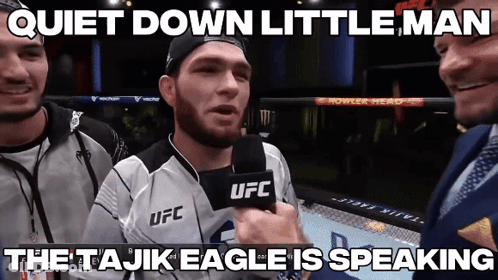 A Man In A Ufc Jersey Is Talking Into A Microphone GIF