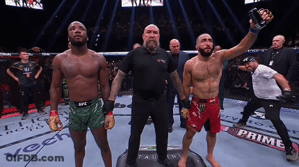 A Man In A Ufc Shorts Is Holding A Bottle Of Energy Drink GIF