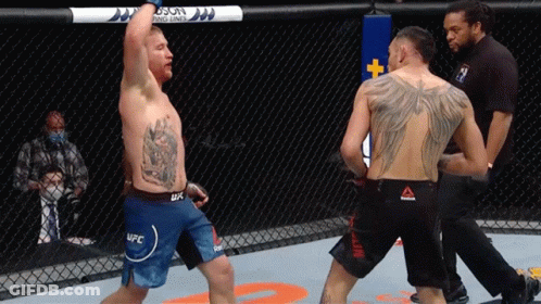 A Man In A Ufc Shorts Stands In A Boxing Ring GIF