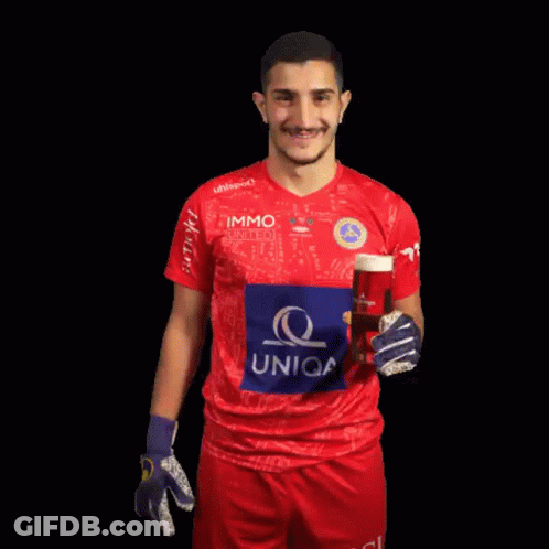 A Man In A Uniqa Jersey Holds Up A Glass Of Beer GIF