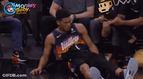 A Man In A Valley Jersey Sits On The Floor With His Legs Crossed GIF