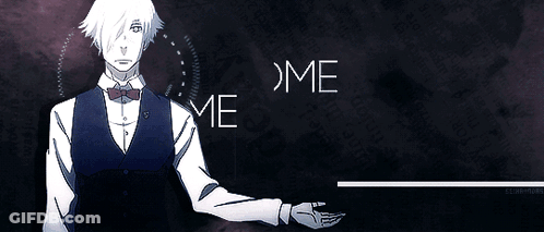 A Man In A Vest And Bow Tie Is Standing In Front Of A Sign That Says Ndeelcome Wel Tocim GIF