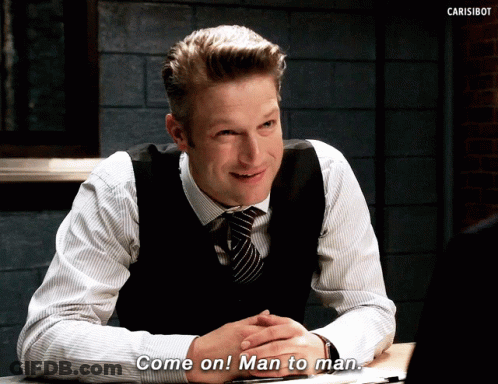 A Man In A Vest And Tie Is Sitting At A Table And Says Come On Man To Man GIF