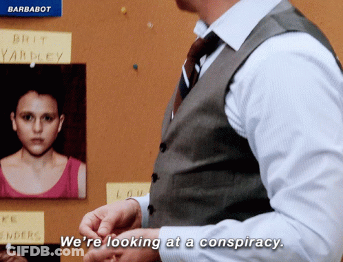 A Man In A Vest And Tie Says We 'Re Looking At A Conspiracy In Front Of A Bulletin Board GIF