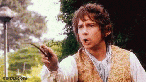A Man In A Vest Is Holding A Stick In His Hand And Making A Funny Face . GIF