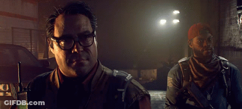 A Man In A Vest That Says ' Army ' On It Is Pointing GIF