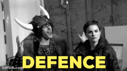 A Man In A Viking Helmet Stands Next To A Woman With The Word Defence In Yellow GIF