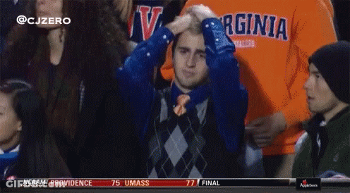 A Man In A Virginia Shirt Holds His Hand To His Head GIF