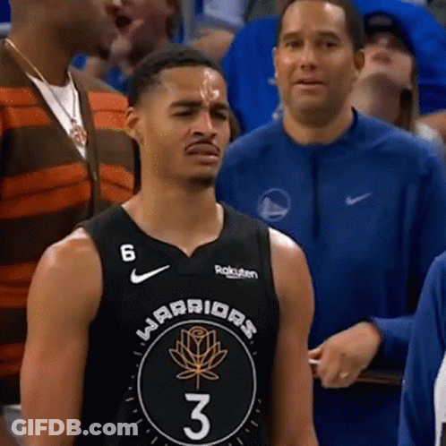 A Man In A Warriors Jersey Stands In A Crowd GIF
