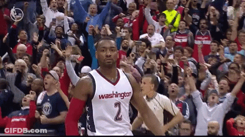 A Man In A Washington Jersey Stands In Front Of A Crowd Of Fans GIF