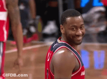 A Man In A Washington Wizards Jersey Is Smiling GIF
