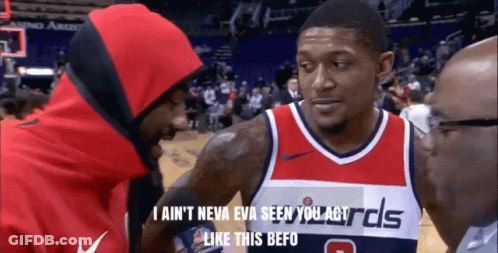 A Man In A Washington Wizards Jersey Talks To Another Man In A Red Hoodie GIF