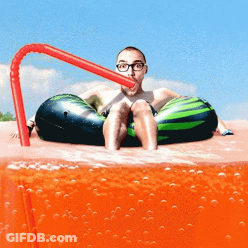 A Man In A Watermelon Float Drinks Through A Straw GIF