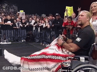 A Man In A Wheelchair Has A Cast On His Leg GIF
