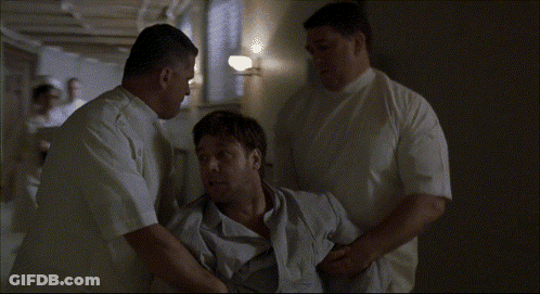 A Man In A Wheelchair Is Being Helped By A Group Of Men GIF